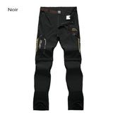 Pantalon de randonnée noir pour homme avec détails jaunes, poches zippées et tissu résistant