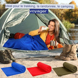 Femme utilisant un sac de couchage polaire bleu en camping, idéal pour trekking, randonnée et bivouac
