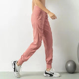 Pantalon de jogging rose pour femme, vue latérale montrant le design ajusté et pratique