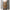 Sac à dos militaire extérieur tenu par une personne, couleur camouflage marron