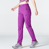 Texte: Pantalon de randonnée pour femmes, couleur violette, taille élastique, poches zippées